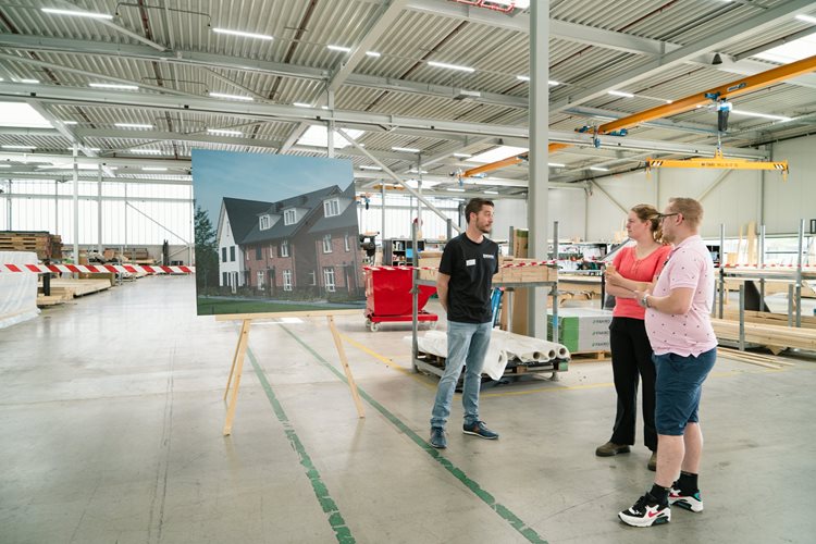 Marcel Ab vertelt aan bezoekers hoe het werk van een assemblagemedewerker er uit ziet bij Emergo Prefab in de fabriek.